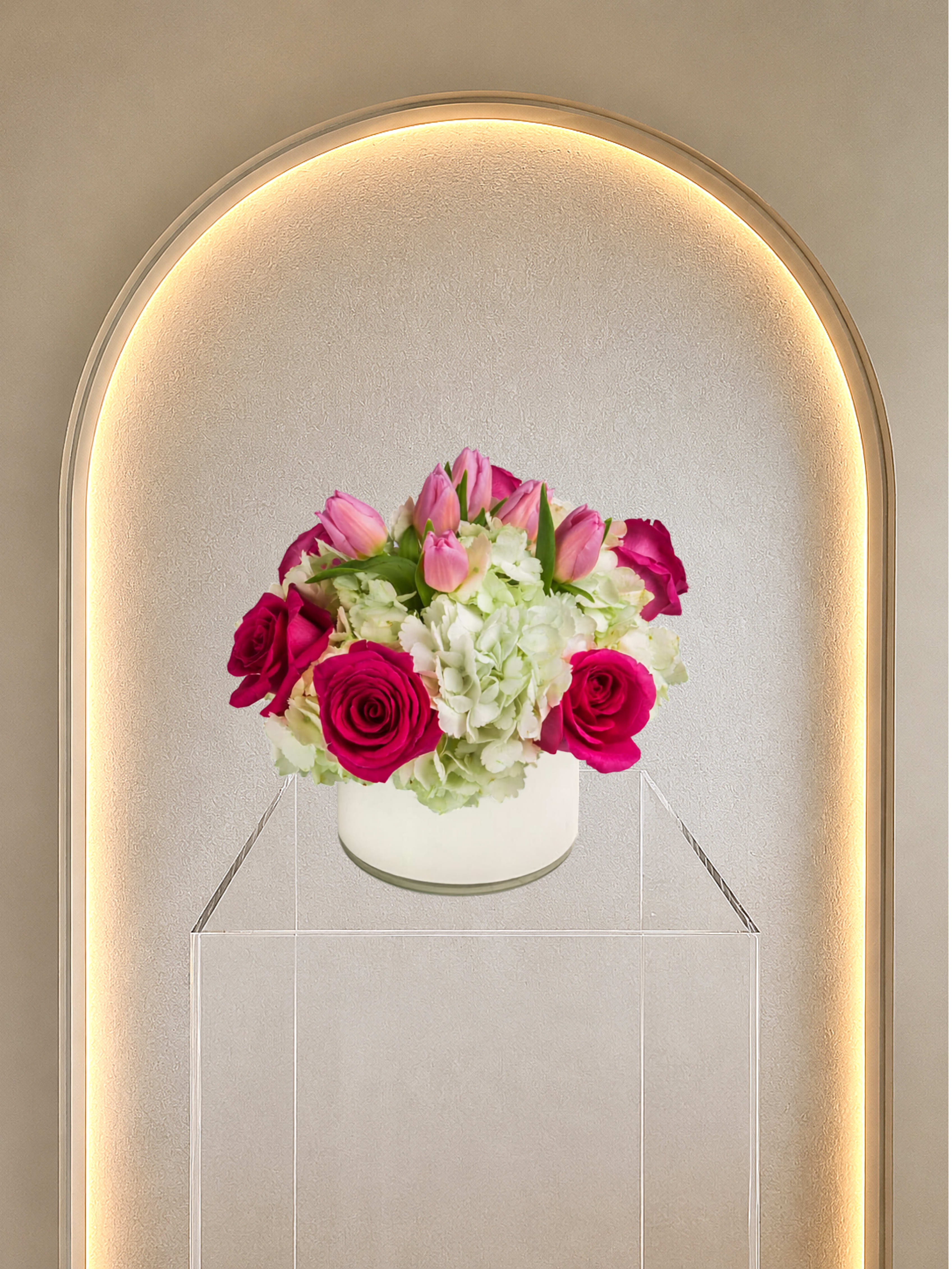 Funday - Pink roses and tulips with pale white hydrangeas in a low vase on a pedestal-elegant, romantic mix of pink, white, and green.  