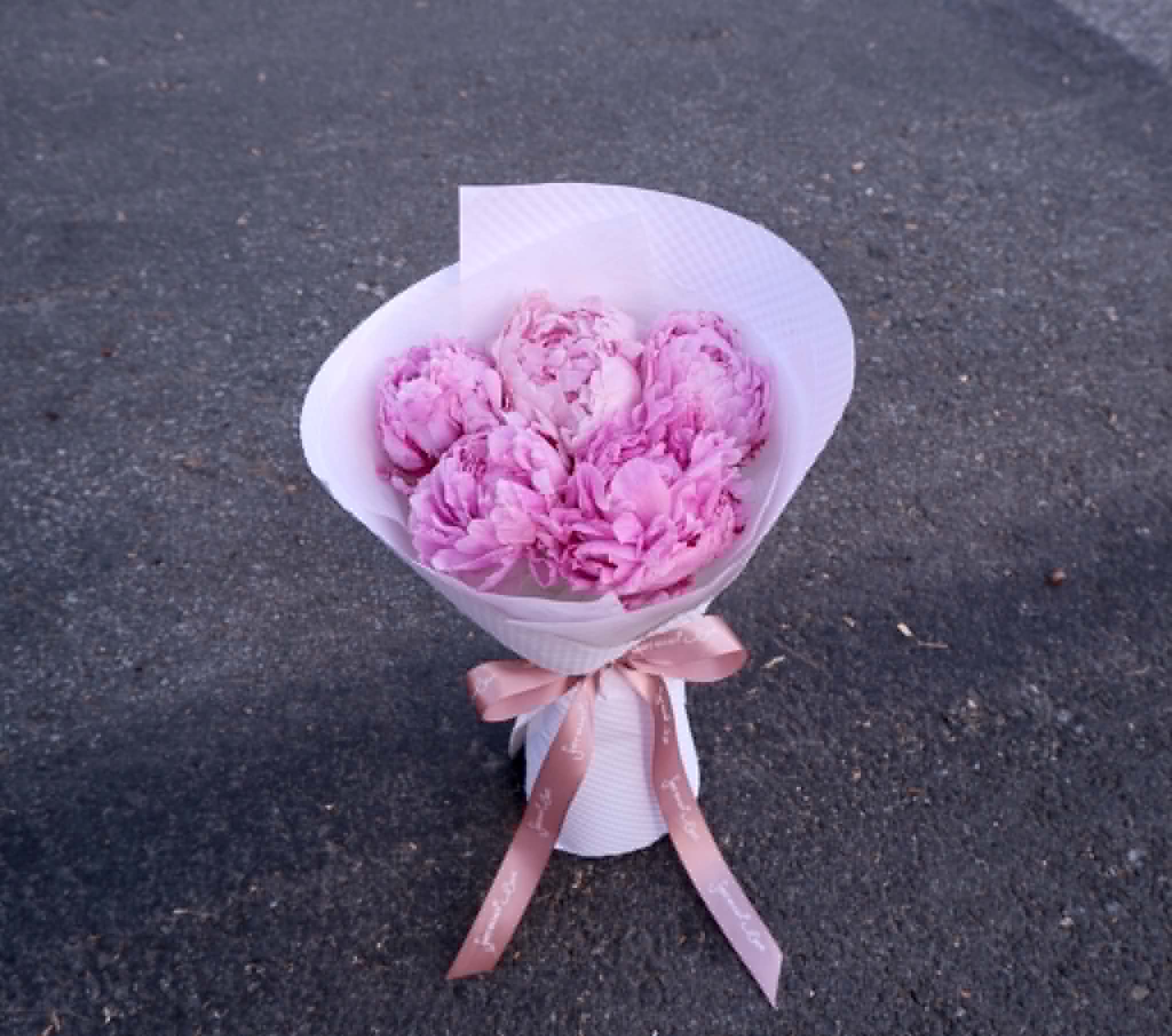 Only Peonies - Lush pink peonies gathered in a soft, cloud‑like bundle, wrapped in crisp white paper and finished with a blush ribbon. Only Peonies celebrates the pure beauty of a single bloom — romantic, full, and effortlessly elegant. A timeless choice for birthdays, anniversaries, or anyone who loves the charm of peonies.