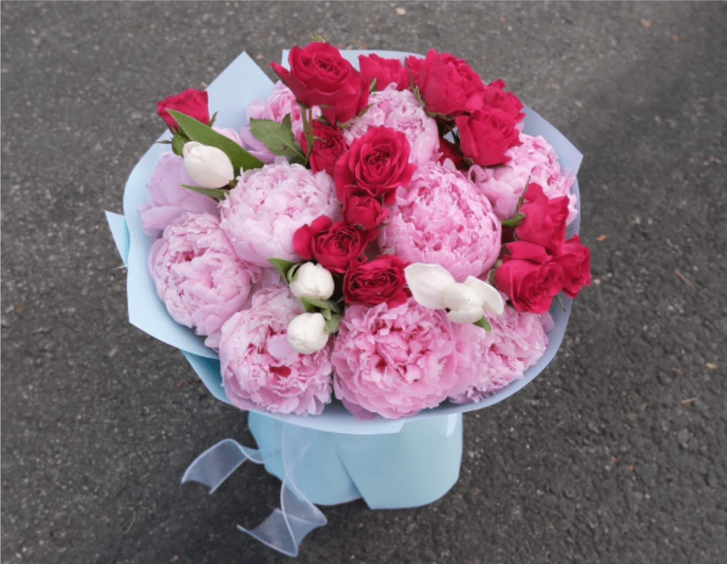 Blushing Peony Luxe - A true showstopper! Our "Peony Cloud Kiss" features lush pink peonies and soft roses in a dreamy, layered cloud wrap. It’s the ultimate romantic gesture—voluminous, sweet, and absolutely breathtaking for any special celebration.