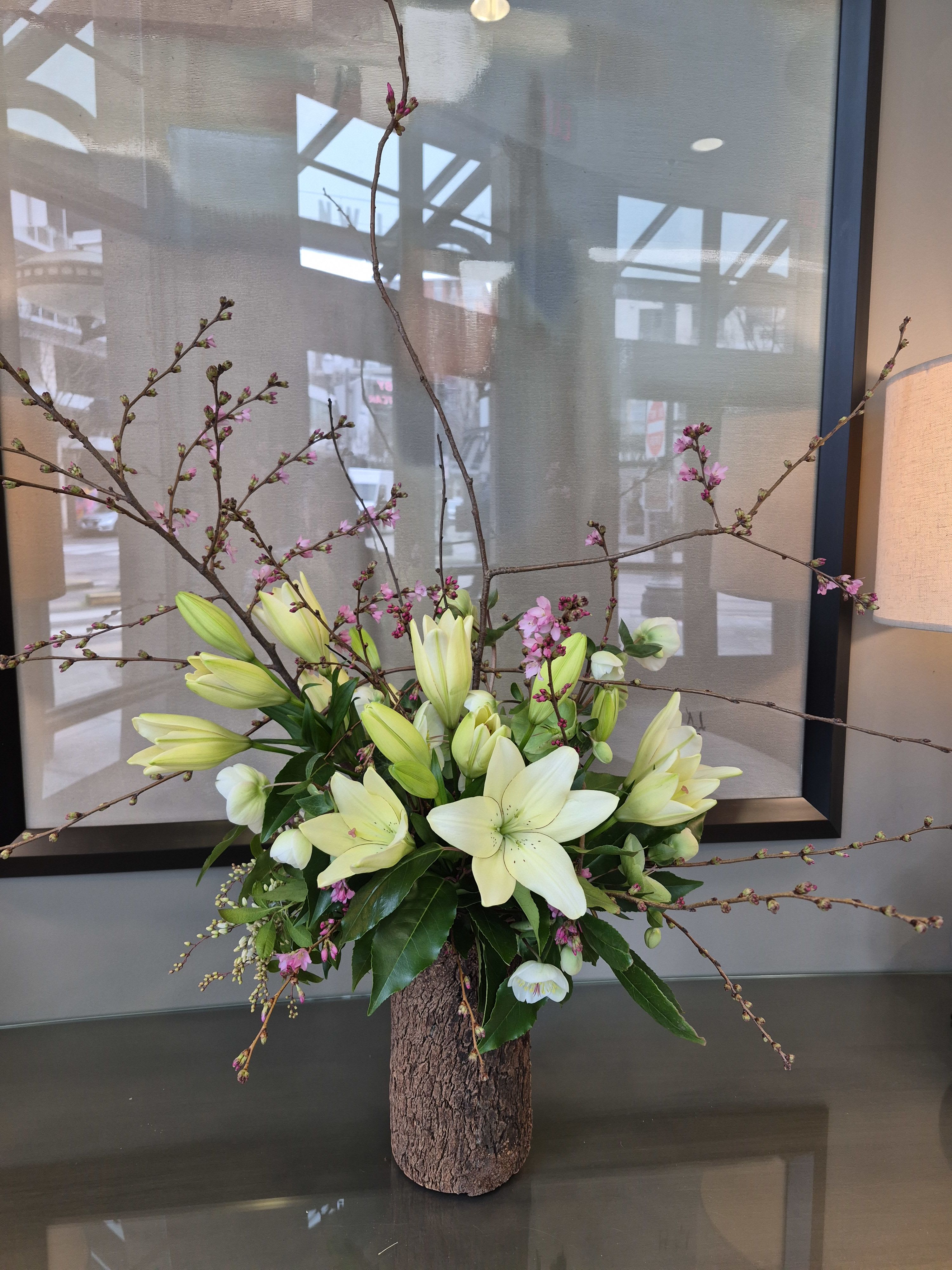 Grace - White, non-fragrant Lilies with the best of the season  ***Please note that Emerald Petals creates with the seasons. What you see pictured is a representation of our style and the general size of the bouquet, intentional substitutes will be made as needed as all of our arrangements are one of a kind like you **A clear vase will be used unless specified