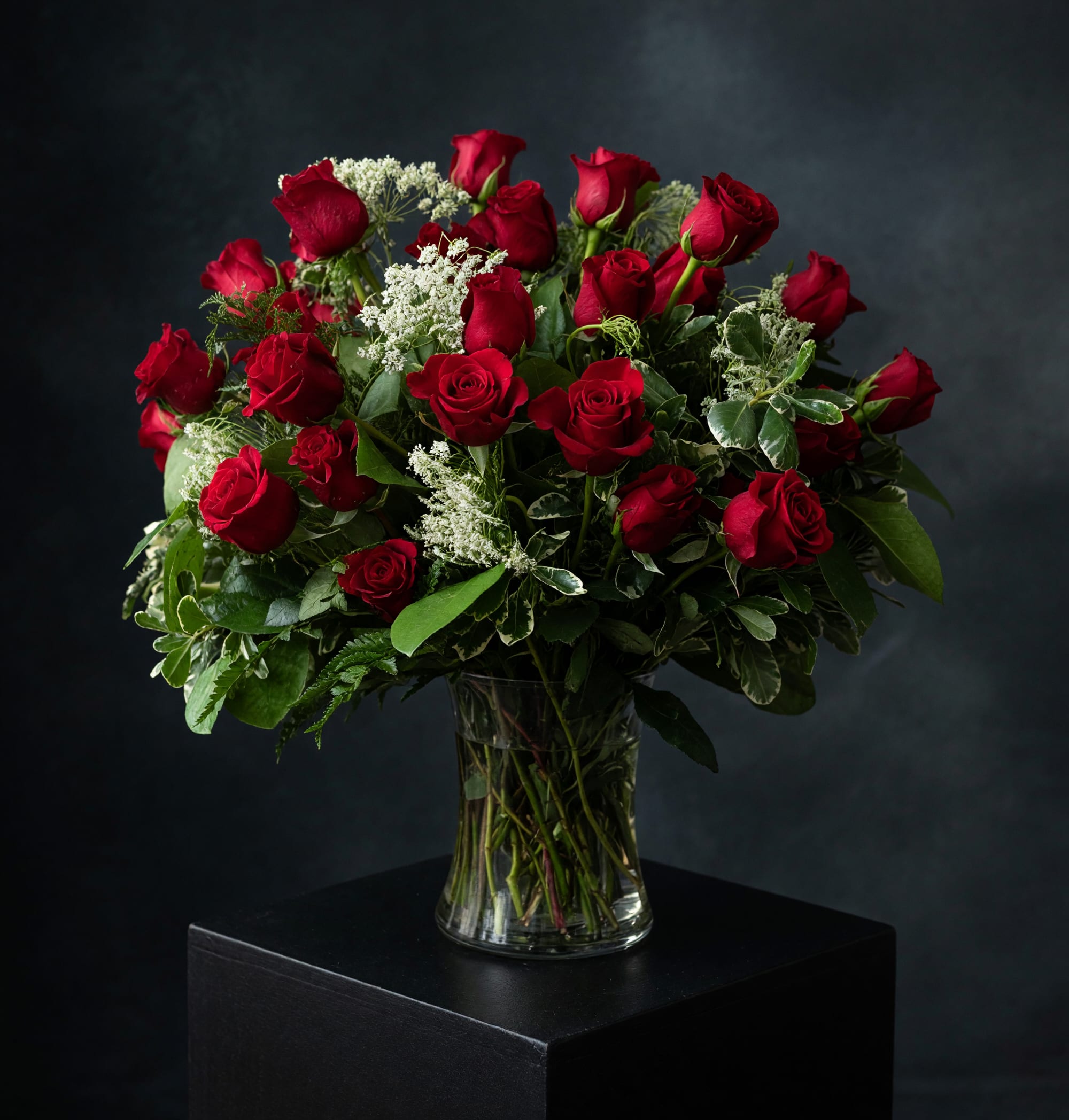Ruby and Lace - A luxurious arrangement of thirty premium red roses accented with delicate Queen Anne's lace and lush seasonal greenery. Romantic, timeless, and designed to make a lasting impression. 