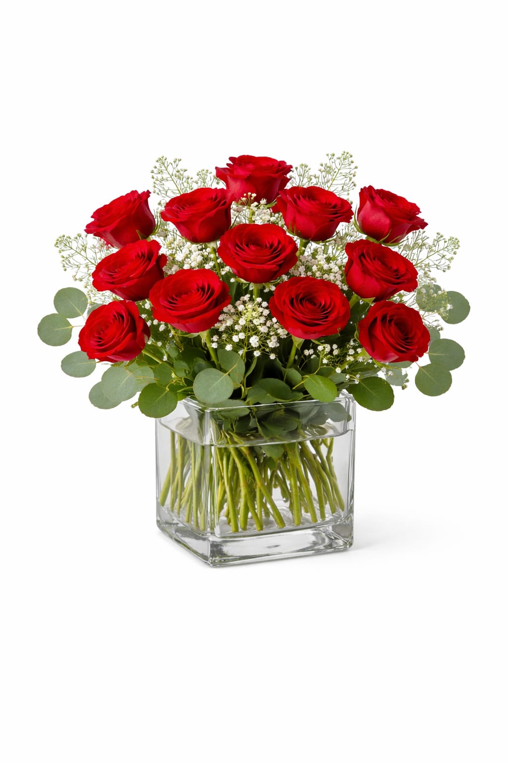 Red roses arranged in a clear square glass vase