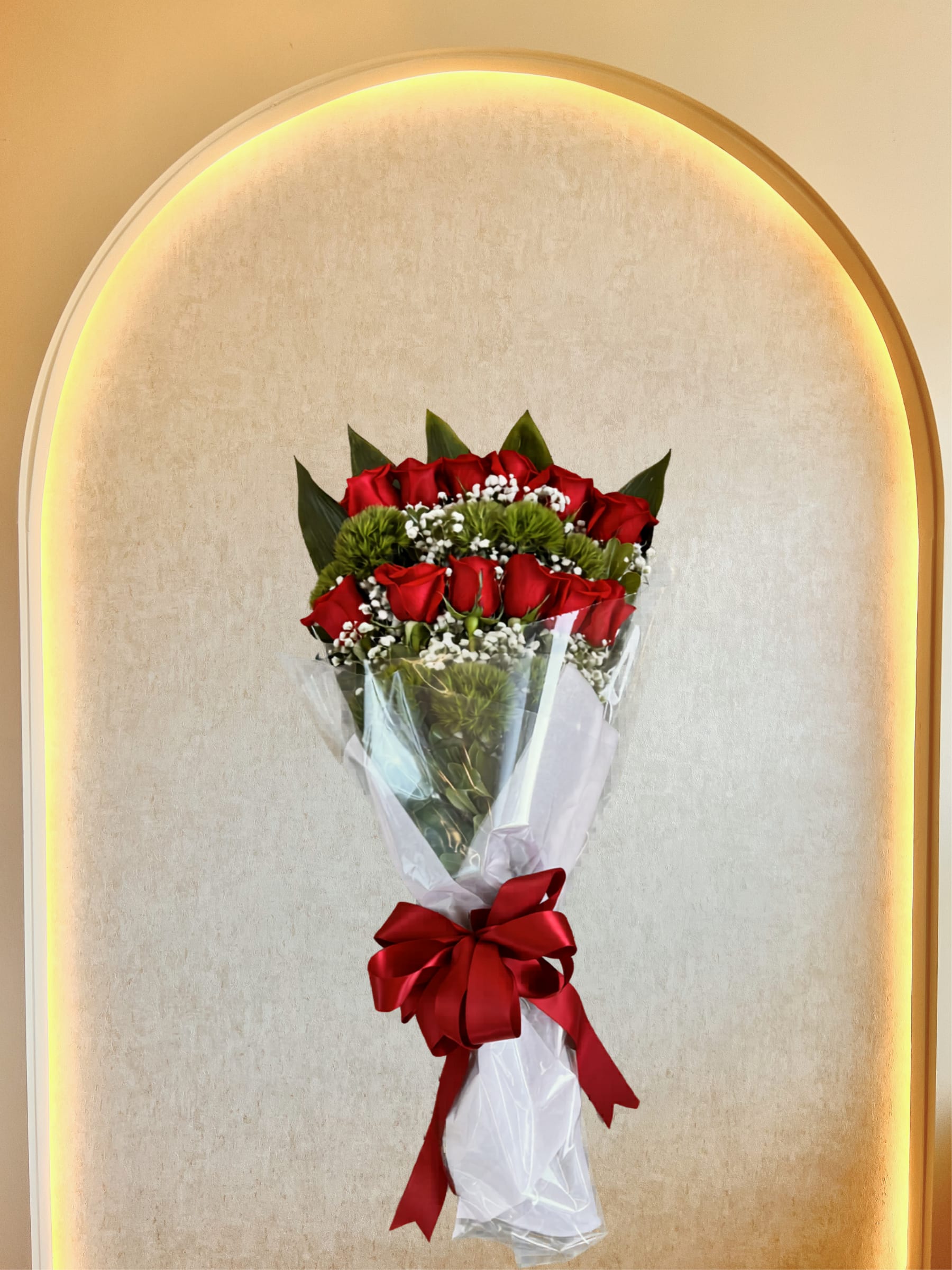 Proposal Bouquet - A beautiful compact and classic proposal bouquet with fresh roses, fillers and greens hand tied in clear wrap and satin bow ready to go. 