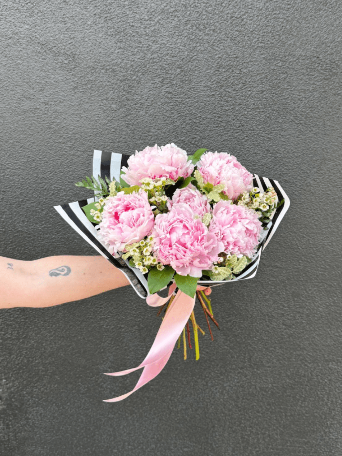 Half-Dozen Peonies - Lush pink Sarah Bernhardt Peonies in a hand-tied bouquet, complemented with fragrant waxflower and fresh greenery.
