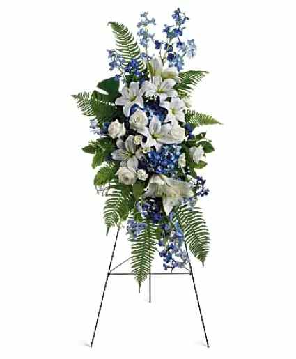 Island Breeze Spray - This standing spray includes blue hydrangea and delphinium, white roses and asiatic lilies, plus tropical ferns and leaves.