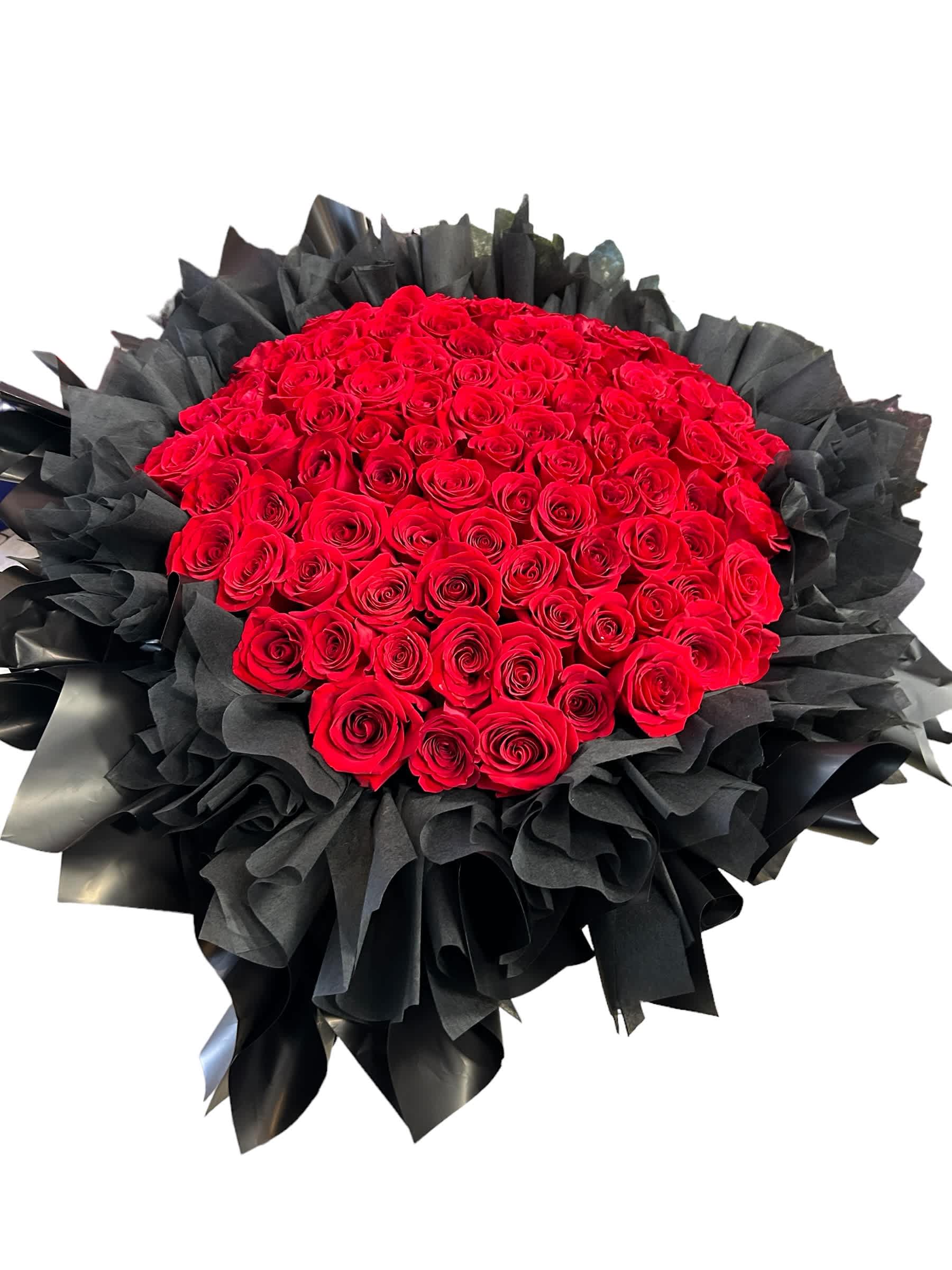 Large bouquet of red roses wrapped in black paper