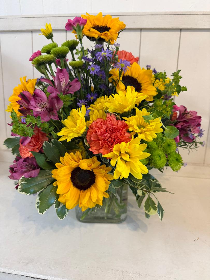 CITRUS VIBES - CITRUS VIBE, HAS A BEAUTIFUL COMBINATION OF BRIGHT COLORS. FILLED WITH SUNFLOWERS, ALSTROEMERIA, CARNATIONS,  DAISIES, FILLER. THIS IS GREAT TO BRIGHTEN UP SOMEONES DAY. FLOWERS MAY VARY DUE TO WHATS FRESHEST ON HAND FOR THE DAY.