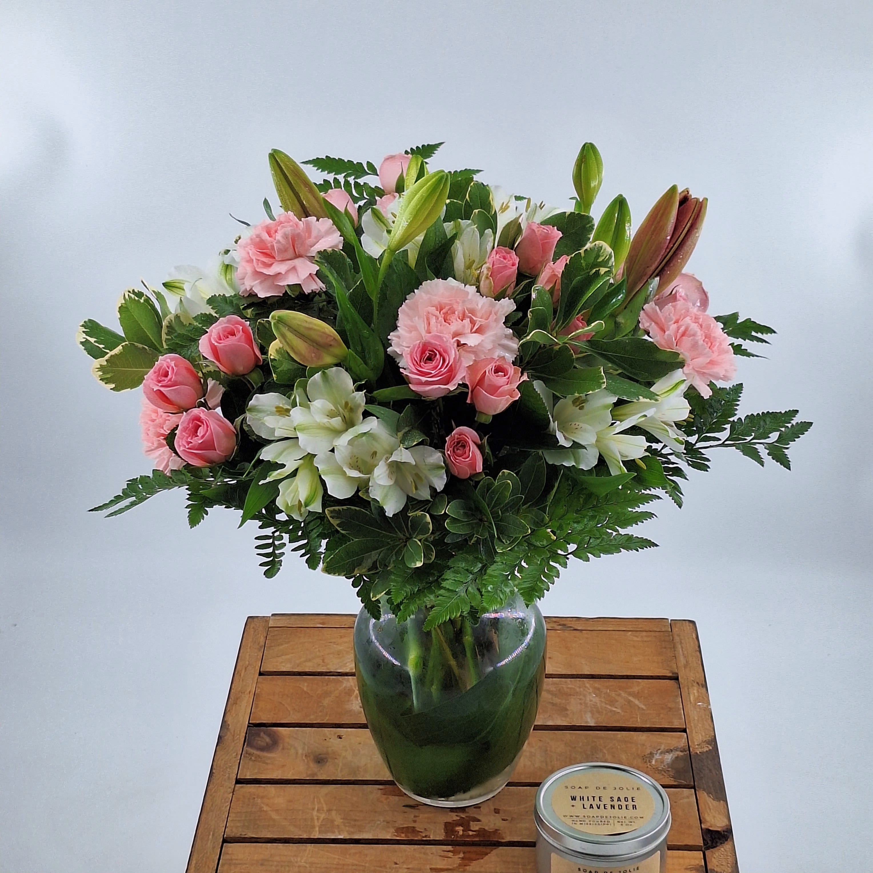 In Style (DB) - Introducing a stunning flower arrangement that exudes elegance and charm. This exquisite bouquet features a delicate blend of soft pink roses, white lilies, white daisies, and white alstroemeria, expertly arranged in a glass vase with lush greenery and filler for a touch of natural beauty.
