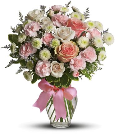 Cotton Candy - Sweet as candy! This soft pink and white bouquet is a feminine choice for any occasion.  A mix of pink and white flowers including roses, miniature carnations and button spray chrysanthemums is delivered in a spring garden vase adorned with pink ribbon. 
