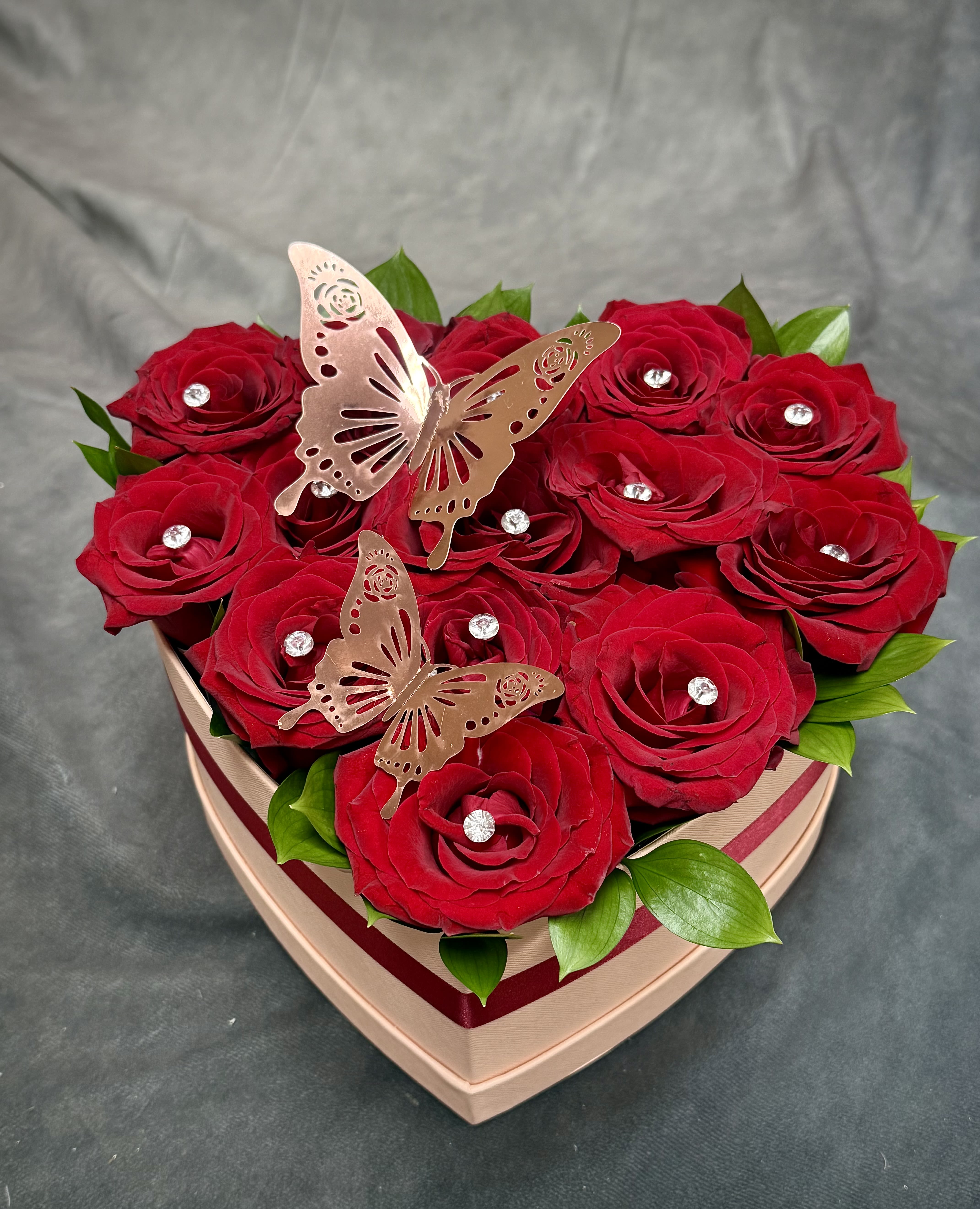 My Heart Box - A luxurious heart-shaped box filled with 14 rich red roses, golden butterfly accents, and Diamonds crafted to express deep love, elegance, and devotion. Deluxe Size has 6 Ferrero chocolate with 14 Red Roses.  