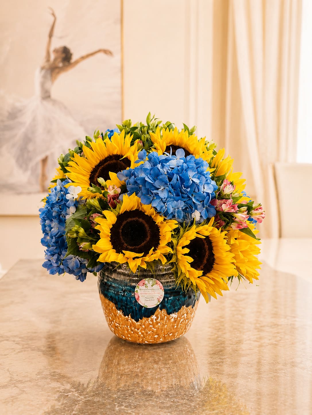 Golden SunFlowers - PLEASE NOTE: The vase can be replaced.  This arrangement feels like a breath of sunshine captured in a bouquet. Sunflowers with beautiful blue hydrangeas.