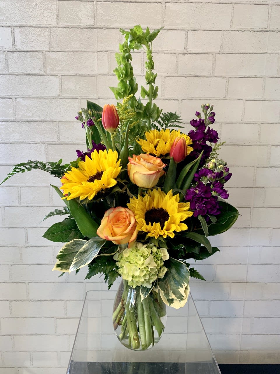 Just Because  - A vibrant collection designed to celebrate color, texture, and timeless beauty.  Our curated selection brings together some of the most beloved blooms—each chosen for its unique charm and the way it elevates any arrangement. Sunflowers add a burst of golden warmth and cheerful energy. Stock offers soft, cloud‑like clusters with a sweet, nostalgic fragrance. Tulips bring elegant simplicity and fresh seasonal color. 