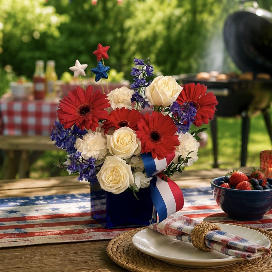Stars &amp; Stems - Stars &amp; Stems is a festive blend of red, white, and blue blooms designed to celebrate in style. Featuring gerbera daisies, roses, delphinium and more, this cheerful arrangement is perfect for the 4th of July or as a thoughtful gesture of appreciation. Stars &amp; Stems brings warmth, beauty and a touch of patriotic charm to any table. 