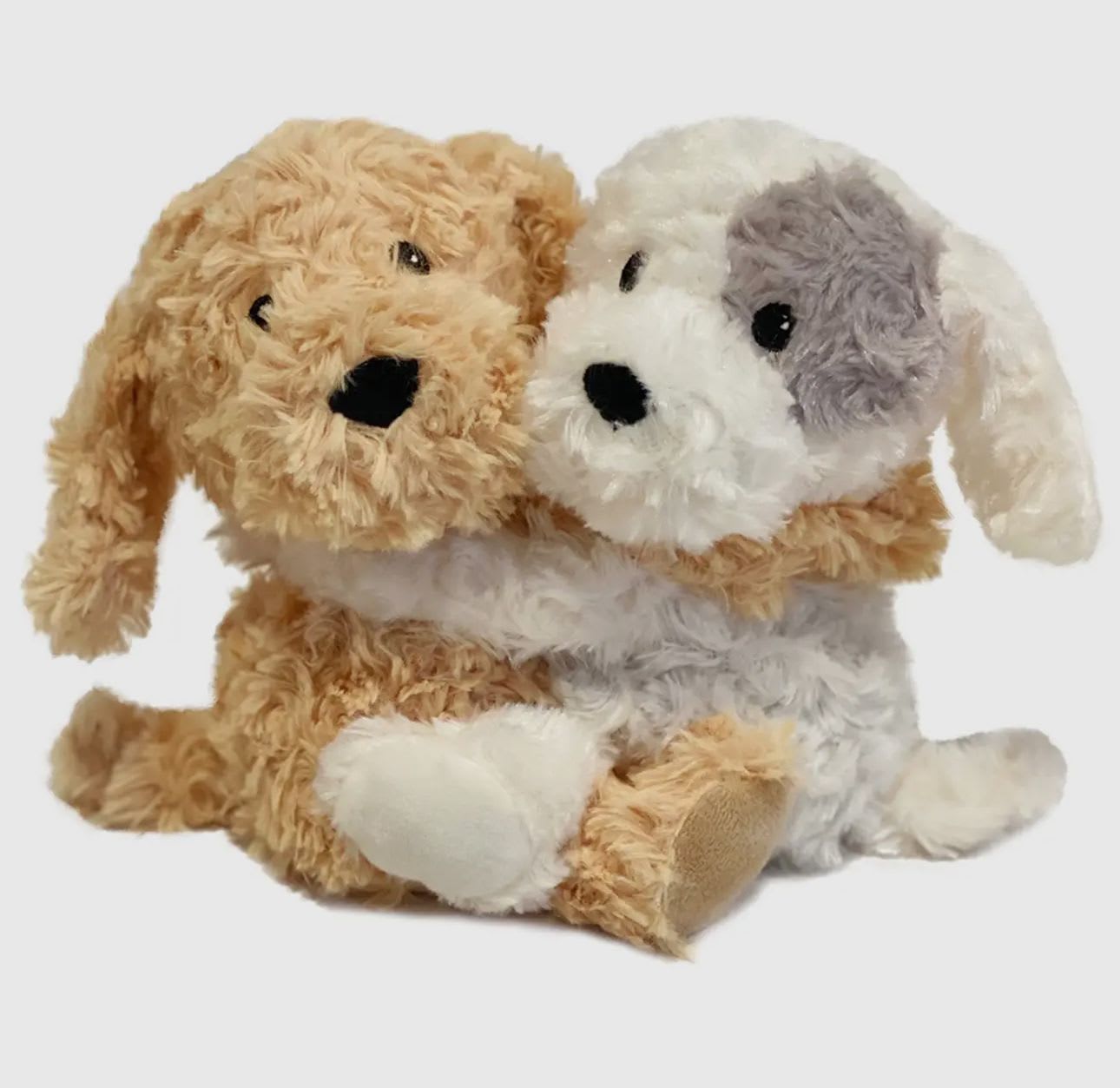 Two plush dog toys sitting together on a white background