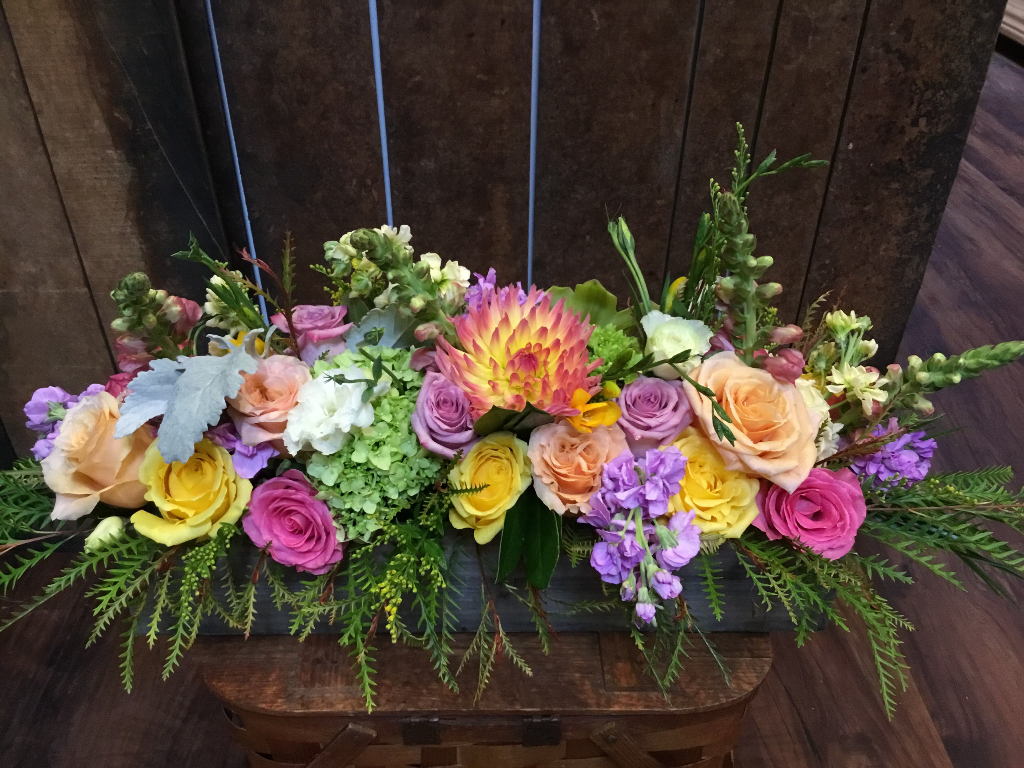 Springtime bonanza  - This vibrant variety of summer time flowers comes in a rectangular wooden box. It features Ecuadorian roses, dalias, stock, freesia, snapdragons, and various different greens. The finished size is approximately 3 feet long.
