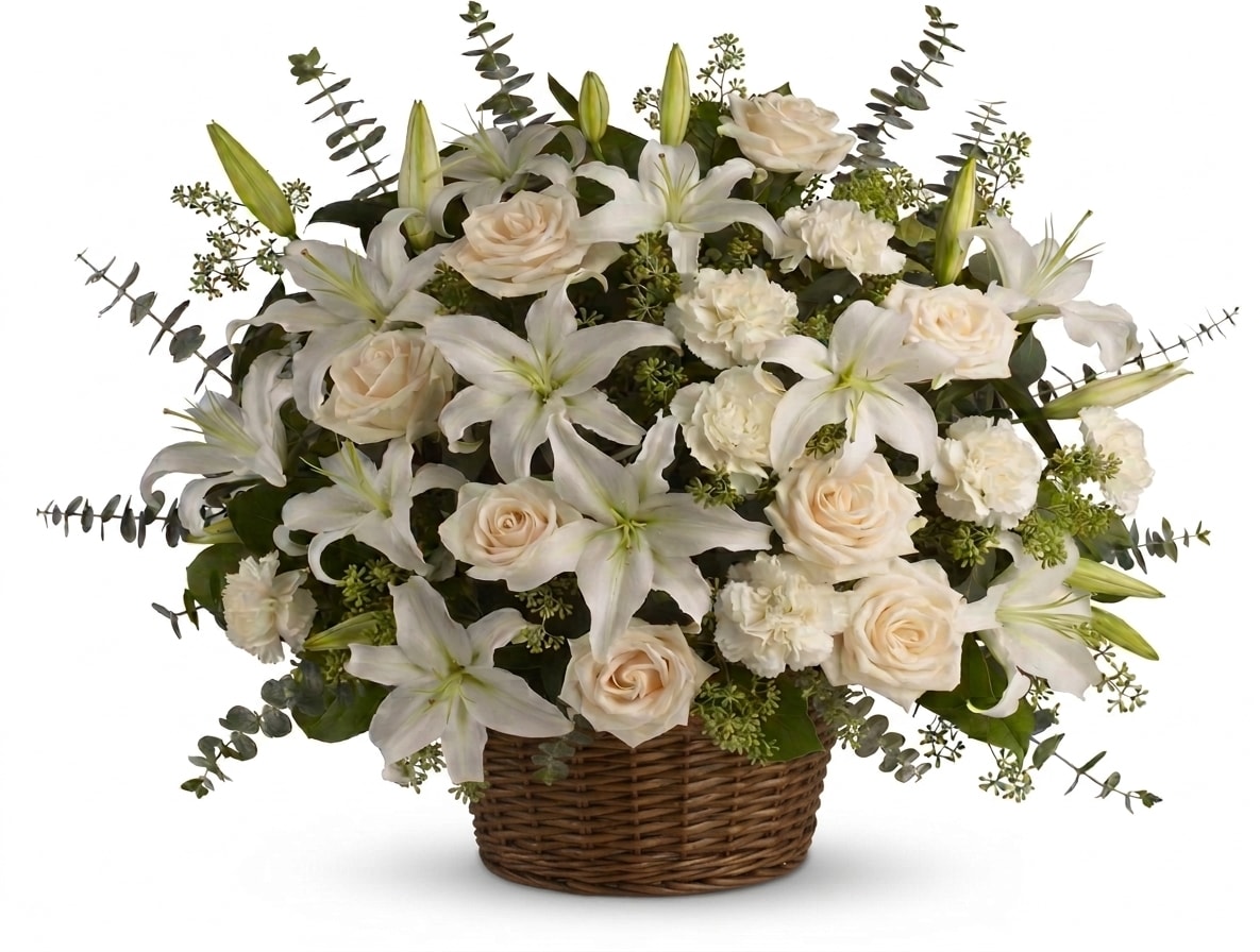 All White Basket Arrangement - Our all-white basket arrangement includes white lilies, white roses, and white carnations. Beautifully displayed in a wicker basket.  