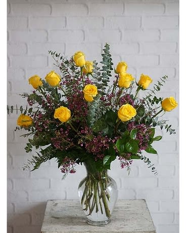 Rosy Glow Bouquet - Yellow roses symbolize friendship, and sending this sunny bouquet of bright yellow flowers is such a beautiful way to celebrate a special bond. Destined to make anyone's day glow, these roses are brilliant!  Glowing yellow roses and solidago mixed with greens are delivered in a clear glass gathering vase. Sunny skies ahead!  Approximately 16" W x 20" H  Orientation: All-Around  As Shown : T70-1A Deluxe : T70-1B Premium : T70-1C 12,18 or 24 roses 