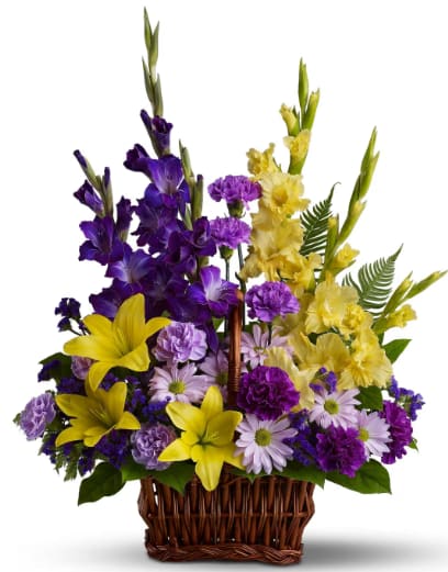 Basket of Memories - Regal purple and yellow blooms are a colorful tribute to a life well lived. This unique sympathy basket accents yellow lilies and purple gladioli with tropical greens and ferns. Beautiful flowers such as yellow asiatic lilies, yellow gladioli, dark purple gladioli, purple and lavender carnations, purple statice, lavender daisies, sword fern and salal.