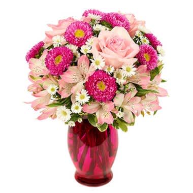 "Sending You Kisses Bouquet" - Bring a splash of beautiful pink to a loved one's life in this bouquet full of pink roses, pink alstroemerias and more. Delivered in a pink vase from a local florist, this Color Me Pink Bouquet is perfect to send for Mother's Day or a birthday. Arrangement Height 12", Length 11"