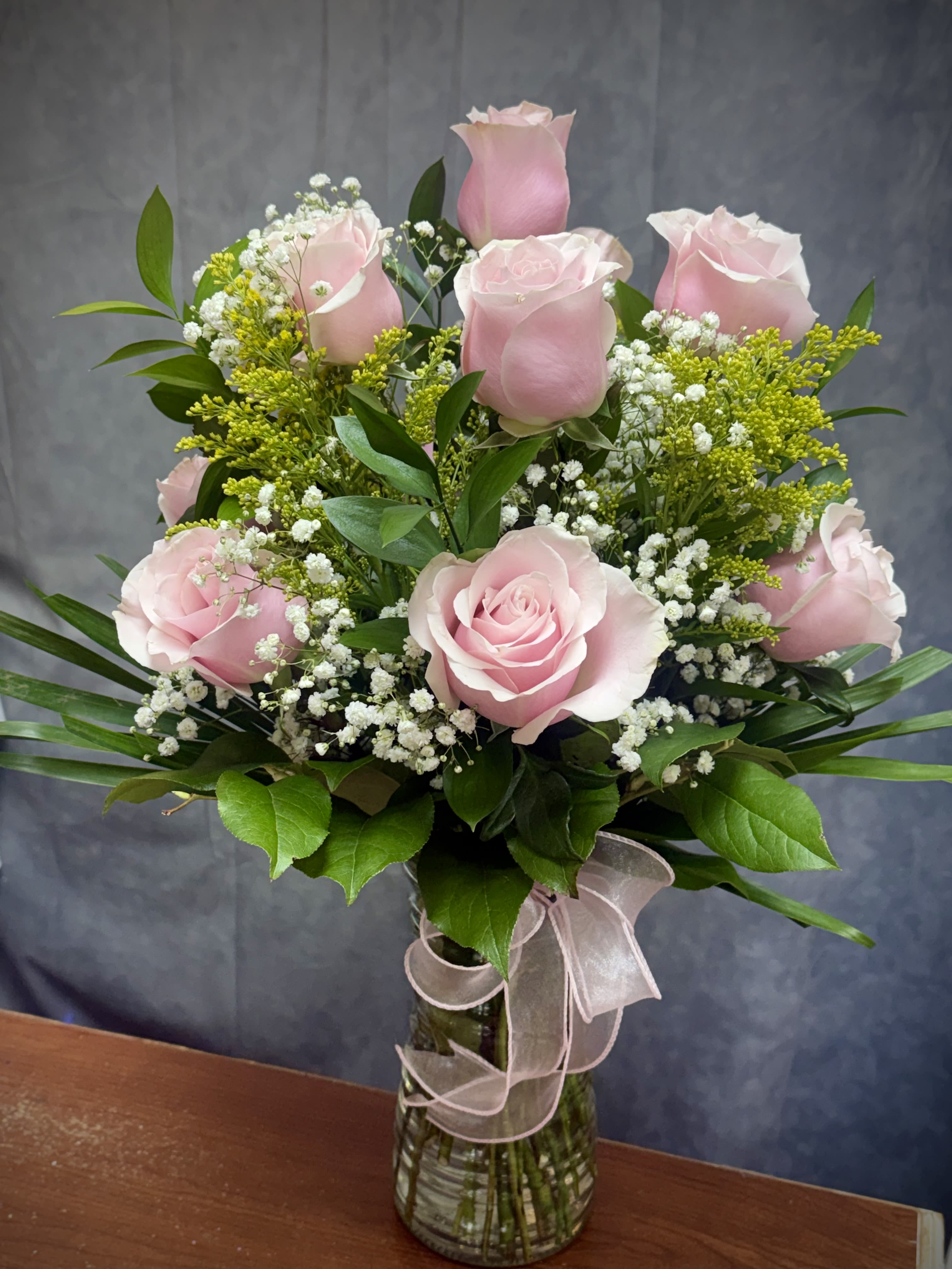 Pink Roses Vase - The perfect pink dozen is a beautiful way to say I love you or Happy Birthday!   Our pretty pink roses arrangements speak volumes! Beautifully hand-arranged with Pink roses, Baby's Breath and Greenery in a vase.   .