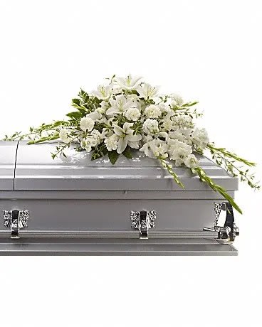 White floral spray on a silver casket