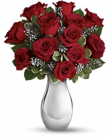 Winter Grace Bouquet - Red and green, the classic of colors of Christmas, are beautifully displayed in this glorious array of red roses accented with the season's freshest greenery. Artistically arranged in a silver reflections vase that will be a favorite for bouquets year-round. The spectacular holiday bouquet features 12 red roses accented with assorted greenery. 