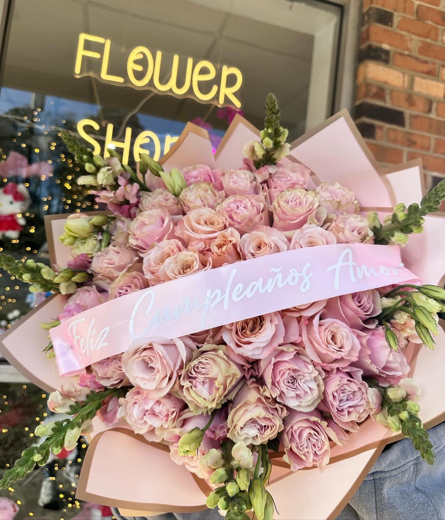 Large bouquet of pale pink roses wrapped in pink paper