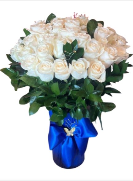 Bouquet of white roses with greenery in a blue wrapped vase