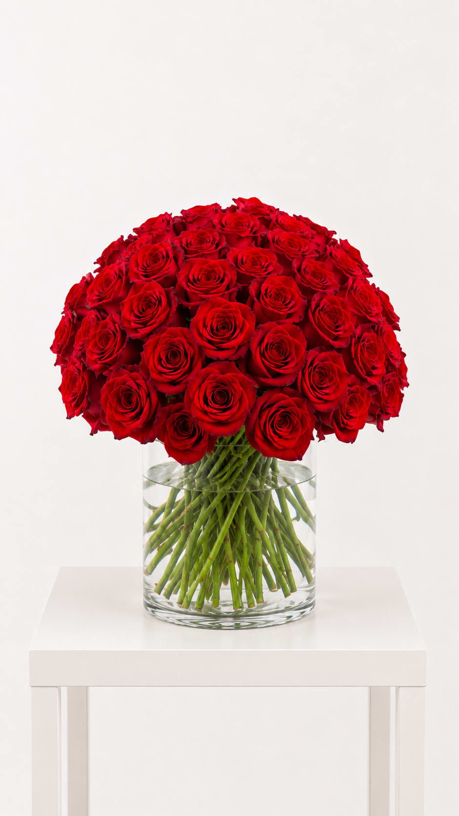Large bouquet of red roses in a clear glass vase