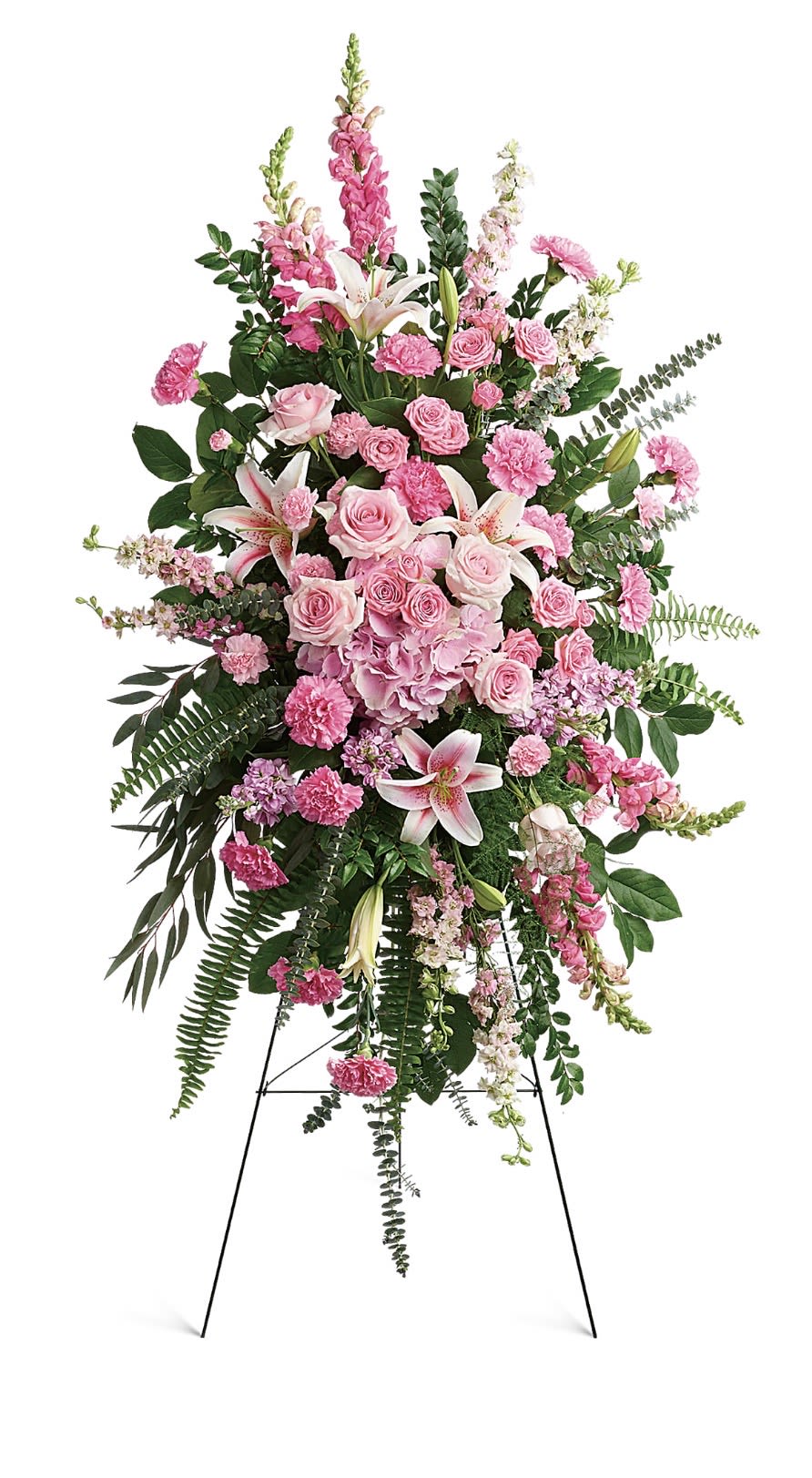 Glorious Farewell Spray - A tall, formal standing spray that reads as gentle and reverent, centered on soft pink roses and pale blooms to create a comforting sympathy arrangement for a funeral or memorial. The design pairs a dense oval heart of roses and spray roses with vertical accents of purple delphinium and white snapdragons, so the person you're honoring will feel remembered with grace and warmth.  Layered with lilies, alstroemeria, carnations, hydrangea, and trailing greenery, the composition offers lush texture and a cascading silhouette that looks beautiful from every angle on the included white easel. Finished with a long lavender ribbon and an easel stand, the piece stands approximately life-size for viewing at a service and presents a refined, ceremony-ready display.  Choose this spray when you want to convey heartfelt sympathy or celebrate a life with a soft, romantic palette; it's the kind of tribute that comforts family and friends while making the memorial space feel both peaceful and dignified. Care is simple-keep the oasis hydrated when possible before placement; the arrangement arrives ready to display on its easel.