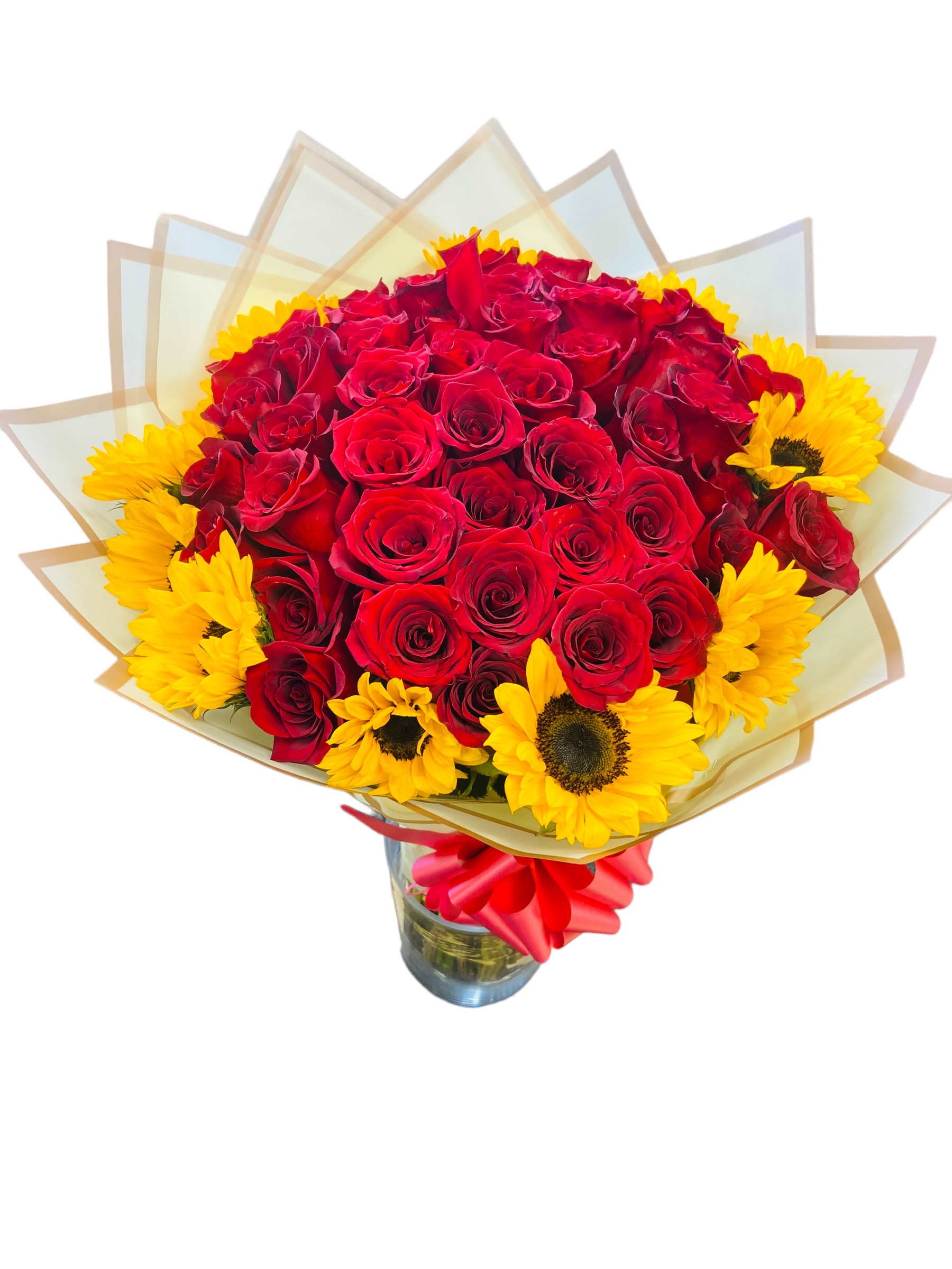 Bouquet of red roses and yellow sunflowers in a glass vase