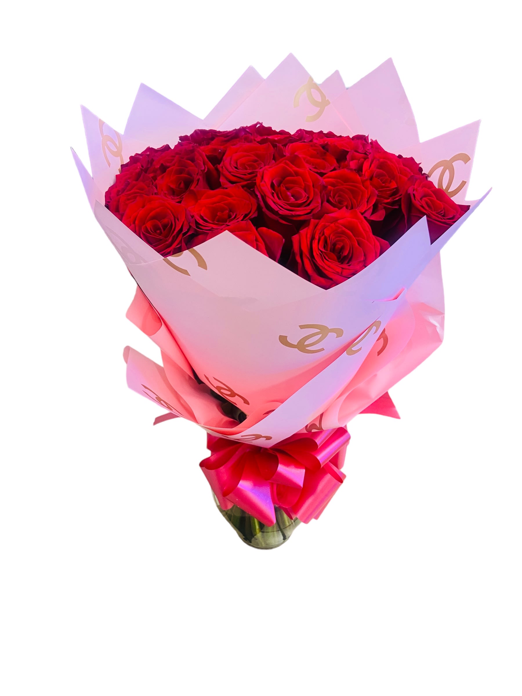 Bouquet of red roses wrapped in pink paper with a ribbon