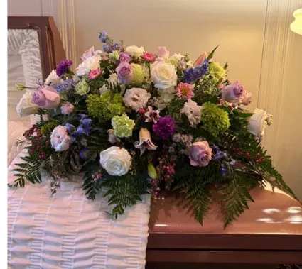Sweet Memories Floral Design - Beautiful lavenders,pink lilies, green hydrangeas and white roses designed for the casket