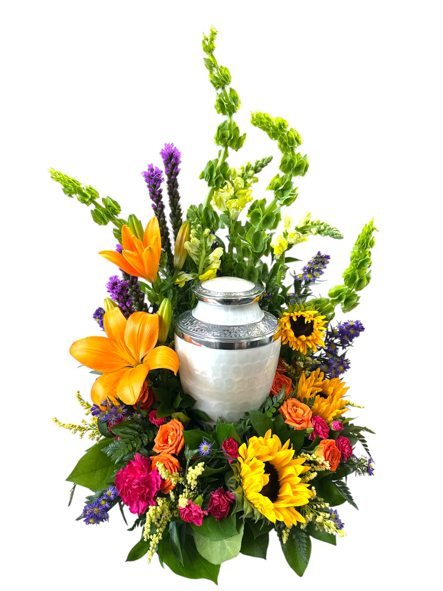 Vibrant Life Round Urn Surround - This vibrant floral arrangement features a cheerful mix of sunflowers, orange roses, purple asters, yellow snapdragons, and other colorful blooms, all beautifully accented with lush green foliage. The combination of bold and soft colors creates a warm, inviting, and celebratory atmosphere, perfect for honoring a special occasion or expressing heartfelt sentiments.  The urn is not included.