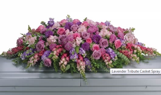 Lavender Tribute Casket Spray - Like a heartfelt embrace, this beautiful casket spray delivers comfort and love in an extraordinary way. A wonderful array of lavender and pink flowers with just the right amount of greenery is a lovely way to pay tribute to someone who will always be with you in heart, mind and spirit.