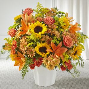 Harvest Thoughts Floor Basket - As the weather changes, Autumn is on their mind. Composed of sunflowers, lilies, and roses, our Harvest Thoughts is a beautiful gesture for birthdays, sympathy, or just because.