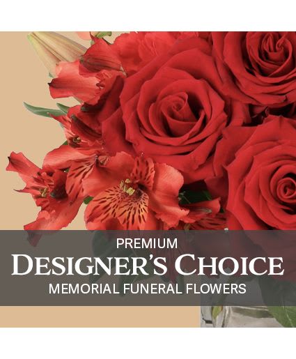 Premium Memorial Flowers Premium Designer's Choice - These tasteful flowers are the perfect way to lift the spirits of loved ones while honoring the memory of the one lost in a beautiful memorial service. Our expert designers will create an impeccable arrangement to surround any photo or urn of your choice. (Urn not included)  *Please note colors and flowers pictured do not reflect the finished product; color and flower selections may vary.