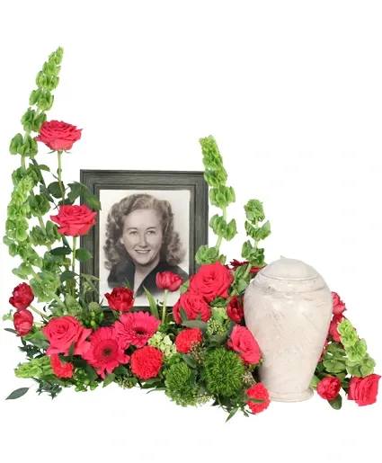 Tender Memorial Cremation Flowers - In a vibrant tribute, Tender Memorial interweaves pink gerberas, roses, and tulips with the graceful presence of Bells of Ireland. Each bloom whispers a heartfelt remembrance, embodying the larger-than-life personality of a loved one. This memorial bouquet captures the essence of memories that will forever remain in your hearts.  Includes: Mache , Laid Flat, Seeded Eucalyptus, Plumosus, Italian Ruscus, Bells Of Ireland, Hot Pink Carnations, Green Trick Dianthus, Hot Pink Gerberas, Green Hydrangea, Green Hypericum, Hot Pink Roses, Hot Pink Tulips.