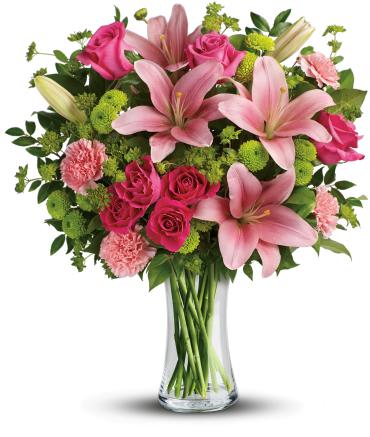 Pink lilies and roses in a clear glass vase
