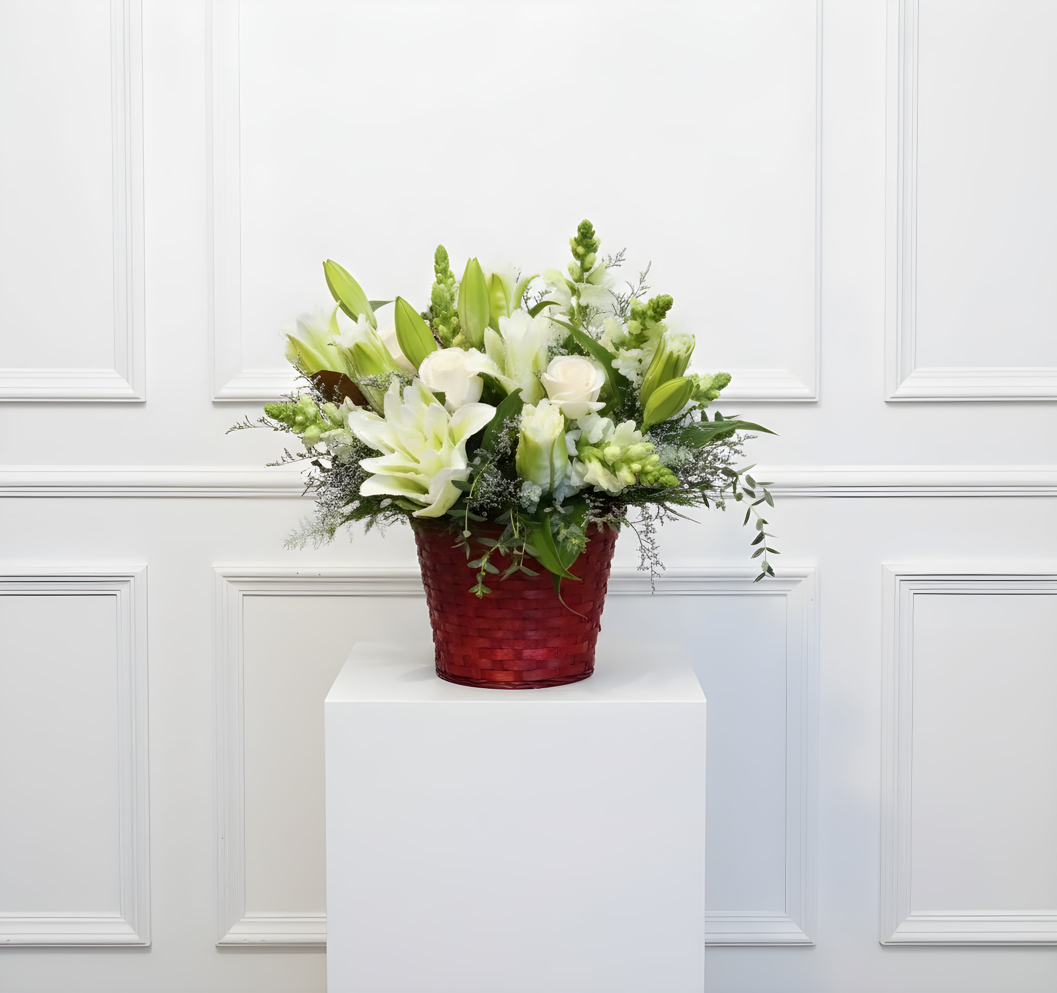 Sympathy basket - This 360⁰ arrangement is approximately 20x20", and is the right choice if you are looking to send something on the smaller side to a service. It features an assortment of foliage and white flowers, designed in a basket.