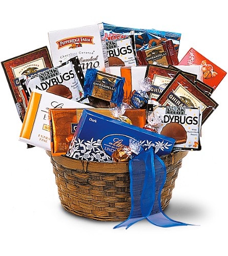 Basket filled with assorted chocolate bars and candy packages tied with a blue ribbon