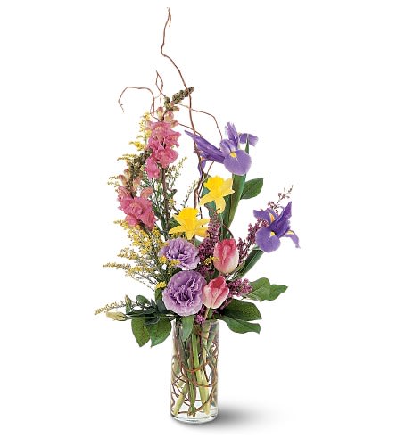 Tall mixed bouquet in a clear glass vase with purple, pink, and yellow flowers