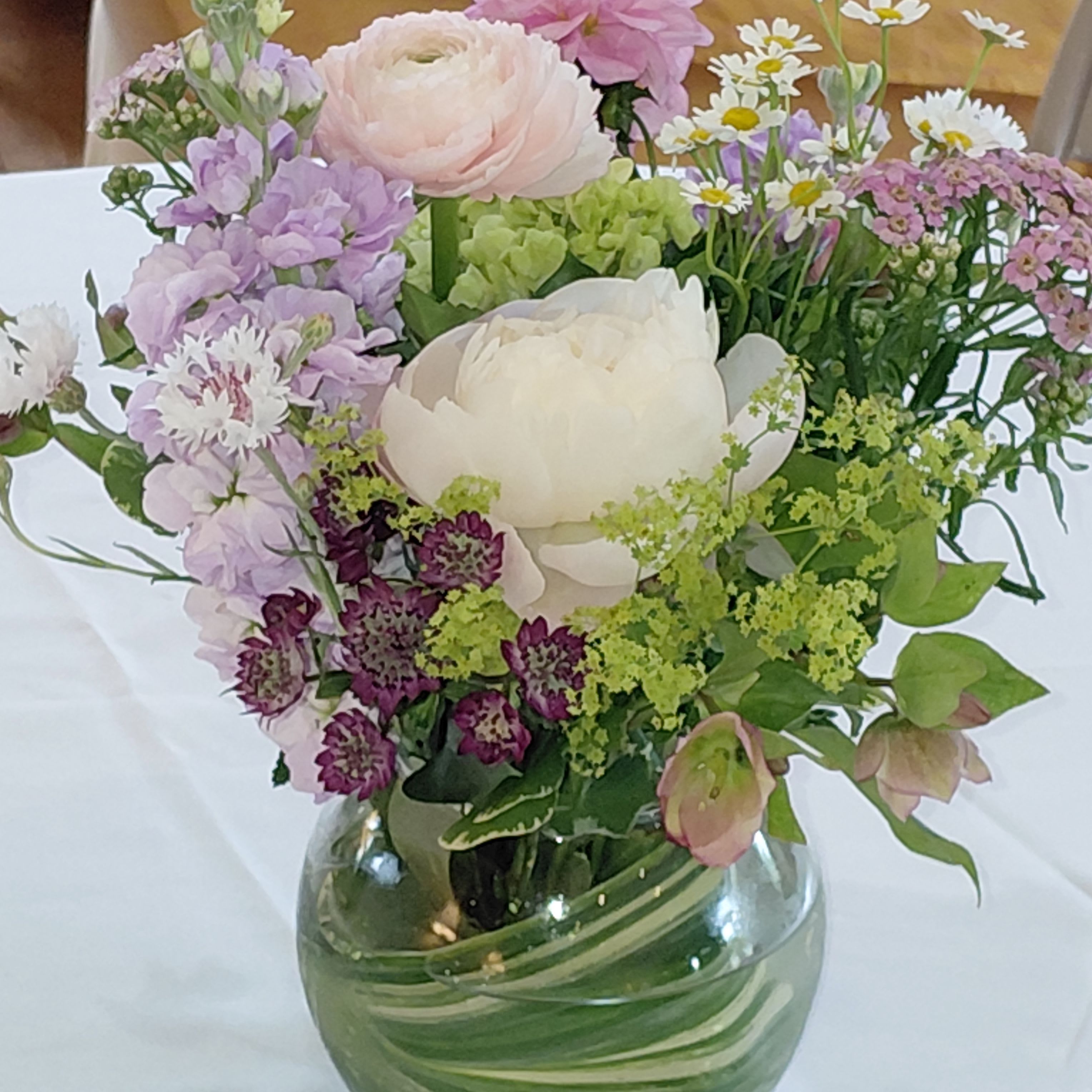 Blooms  Summer Garden Arrangement - Seasonal Flowers, Roses, Peonies (Seasonal), Ranunculus(Seasonal),  Daisies, Helleborus,  Spray Roses, Seasonal Greenery