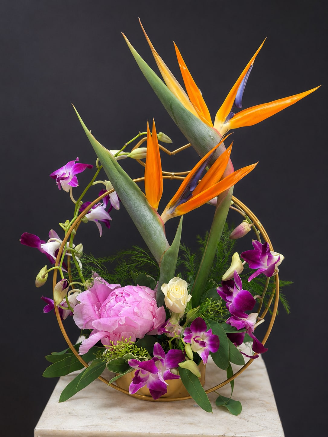 Elegant Paradise  - This beautiful and elegant arrangement made with bride of paradise , pink peony and dendrobium orchid in s golden color metal container . 