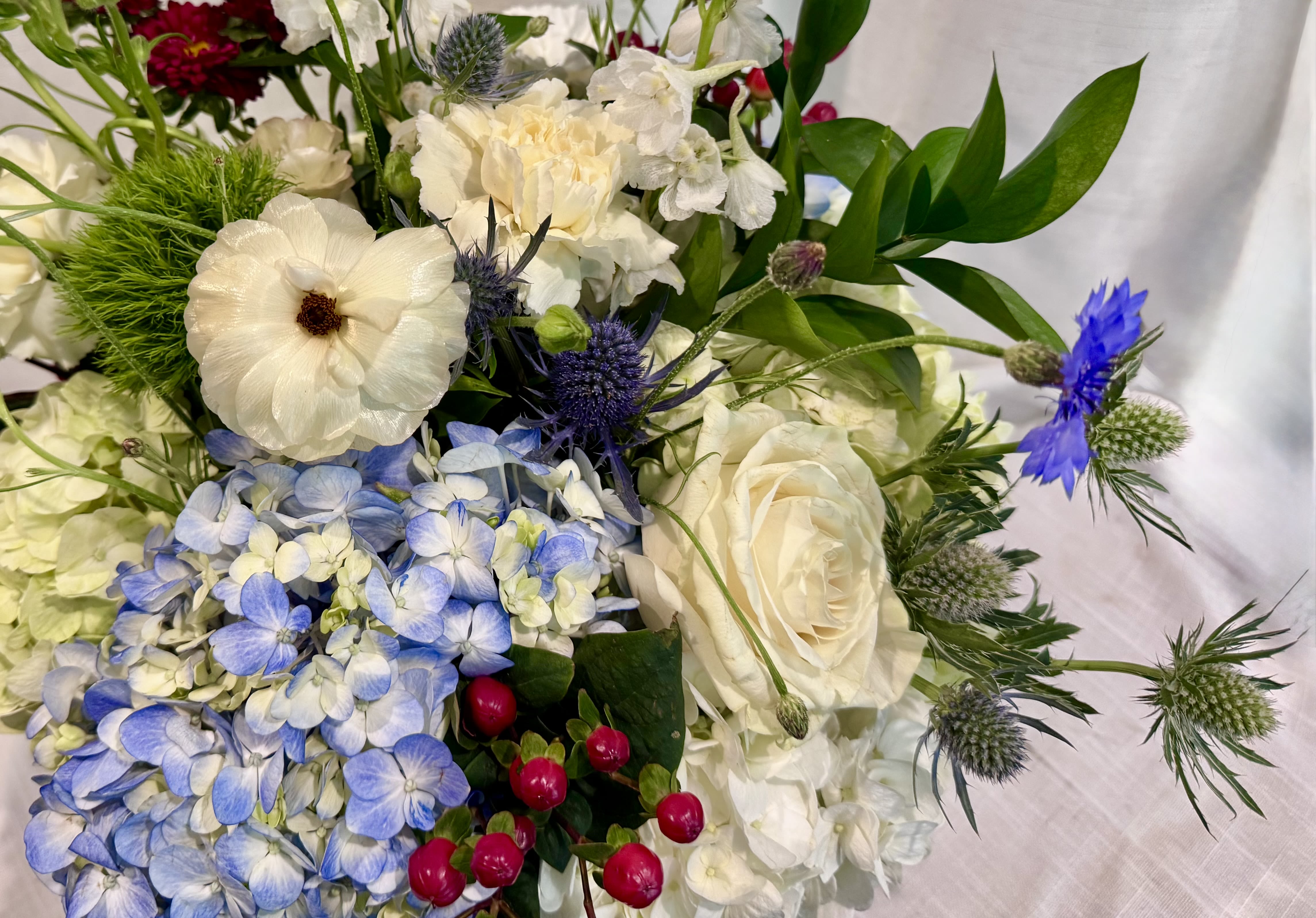 Designers Red White and Blue, just for you!  - A mix of red, whites and blues designed with a mix of unique flowers. With Hydrangeas of course!  Our team enjoys creating beautiful and unique designs, tasteful and structured with a natural garden feel. 