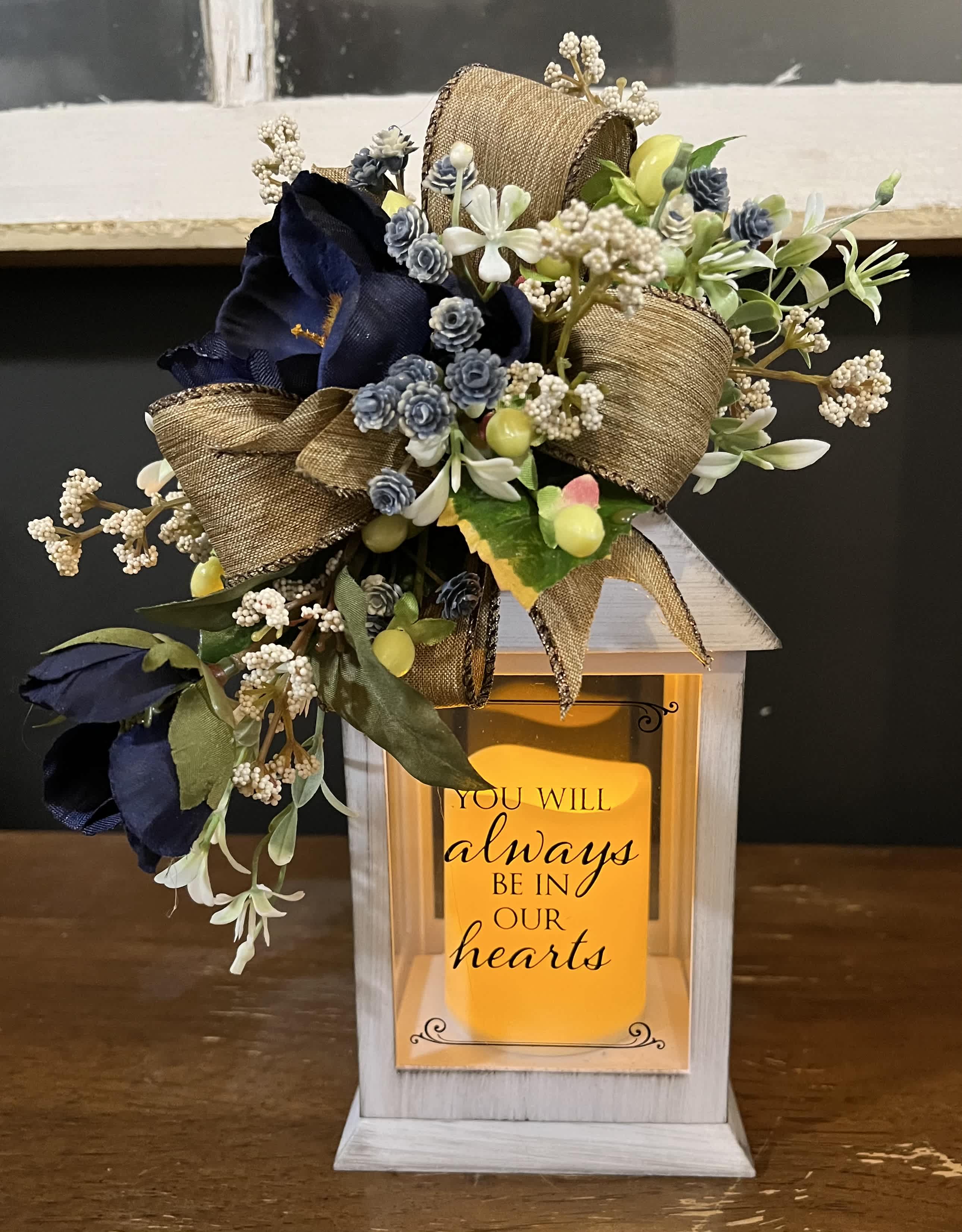 Floral memorial lantern with navy flowers and a sympathy message