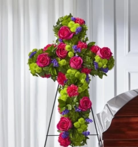 Vibrant Tribute Cross - This vibrant and beautiful cross has roses, statice, dianthus and button pompoms and is a glorious way to remember your loved one.