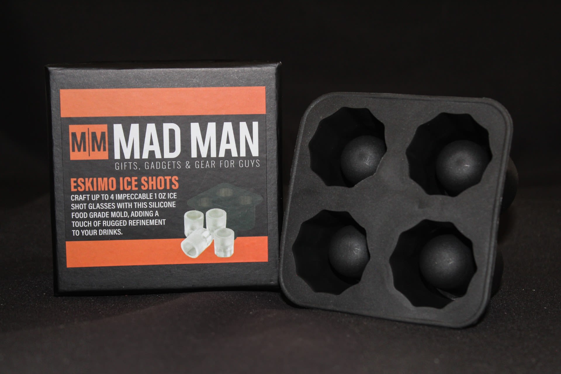 Eskimo Ice Shots - A set of four ice shot molds designed for party-ready chills - perfect as a masculine gift or hostess surprise for birthdays and holiday entertaining. This ice shot glass kit makes a playful bar accessory for the person who loves to host: it reads like a rugged novelty present that turns any toast into a moment worth remembering.  The kit includes a black silicone mold that produces four square-cavity frozen shot glasses.   Give this to a friend who enjoys at-home cocktails, a newly moved roommate setting up a home bar, or someone celebrating a milestone with close company - it's a fun, usable gift that makes guests smile. For best results, fill the silicone cavities with water (or flavored liquids), freeze fully before unmolding, and rinse the silicone before first use; the compact size ships ready in its retail box for easy gifting.