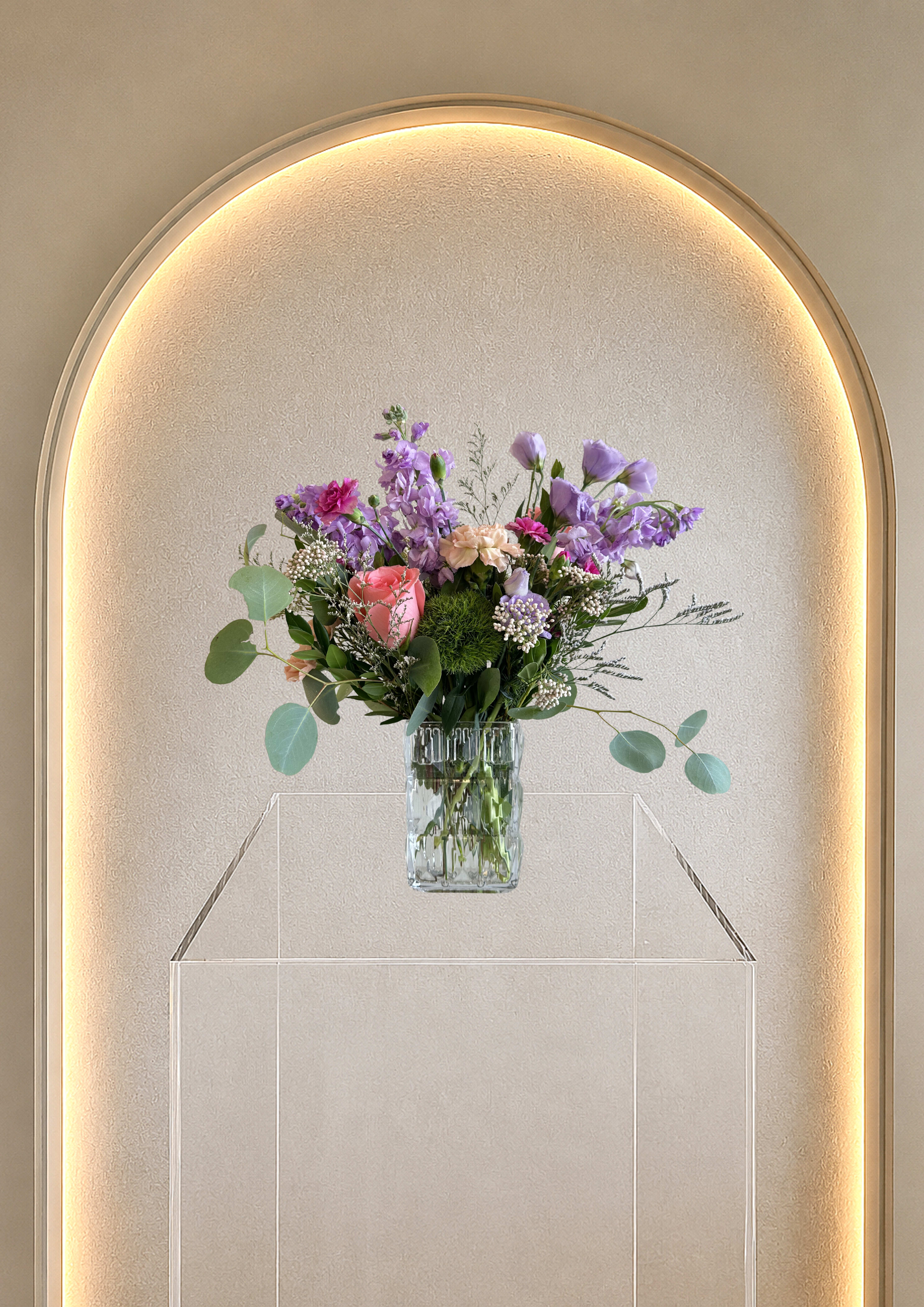Crystal Blossom - A collection of pastel flowers in this arrangement designed in a beautiful vase, a great combination of beauty and a thoughtful gift. 
