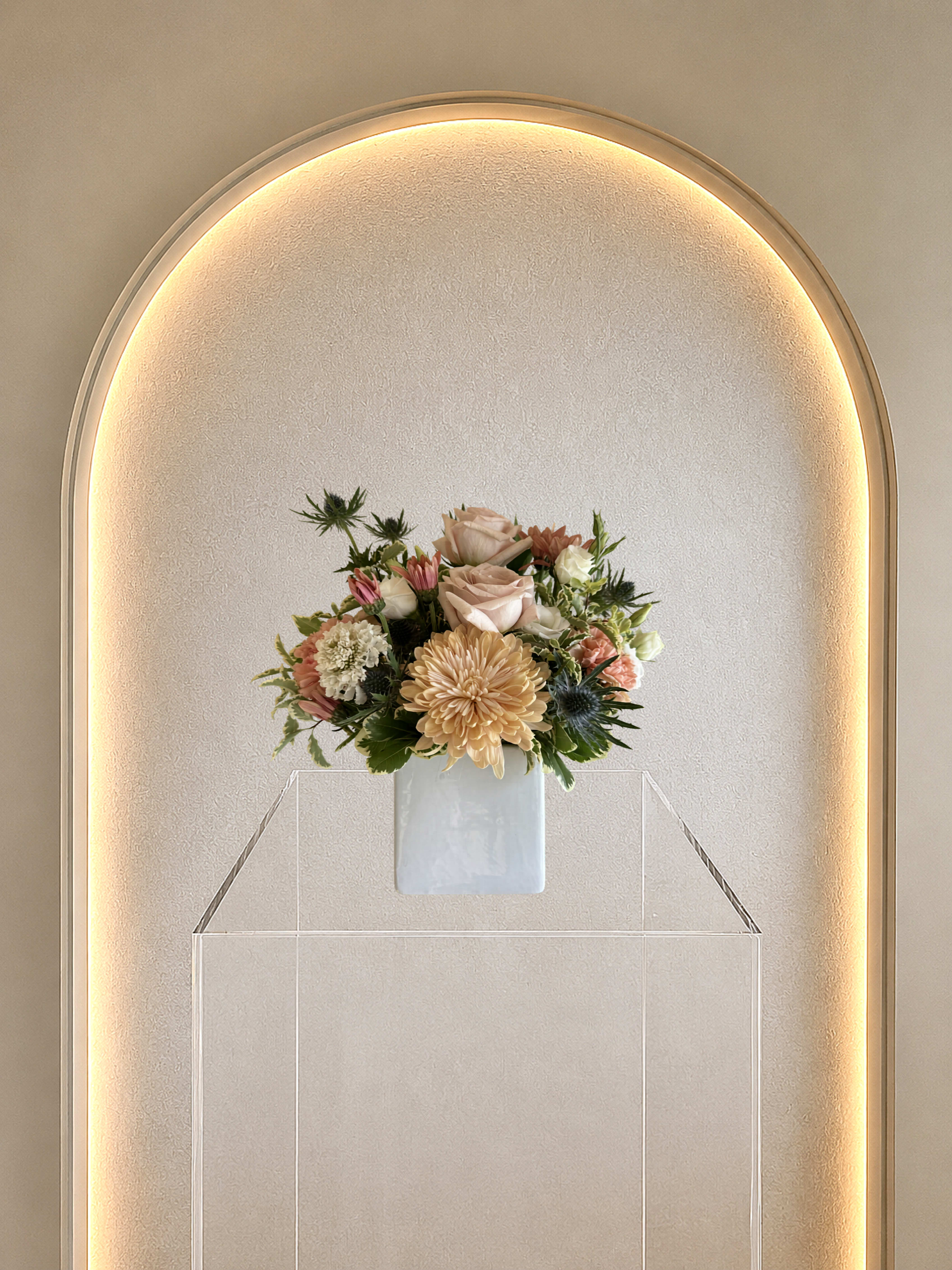 Garden Cube - A compact cluster of soft blush roses and peach mums, a calming centerpiece and great gift. 